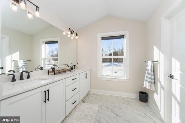 bathroom with vanity and vaulted ceiling