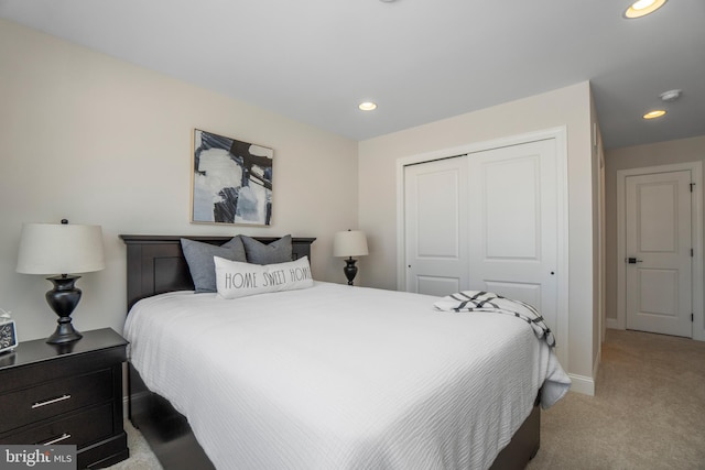 bedroom with light colored carpet and a closet