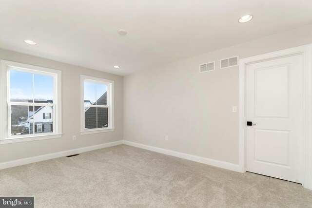 empty room featuring light carpet