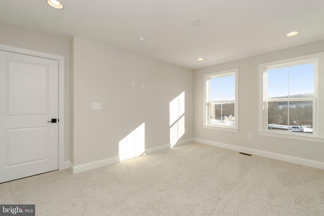 spare room with light colored carpet