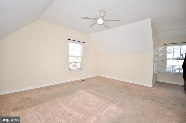 bonus room with ceiling fan, light colored carpet, and lofted ceiling