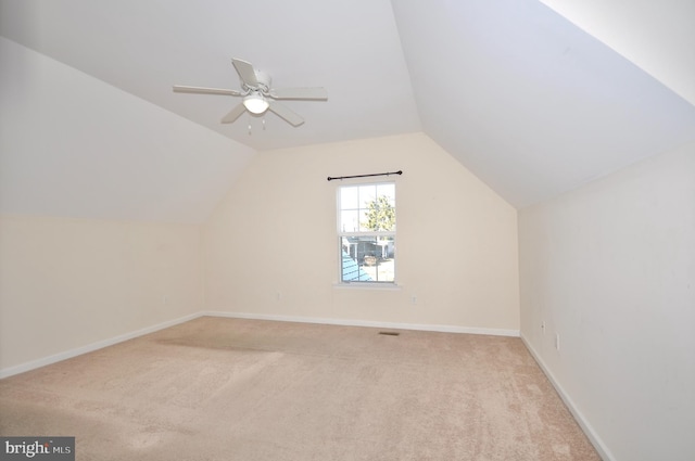 additional living space featuring light carpet, ceiling fan, and lofted ceiling