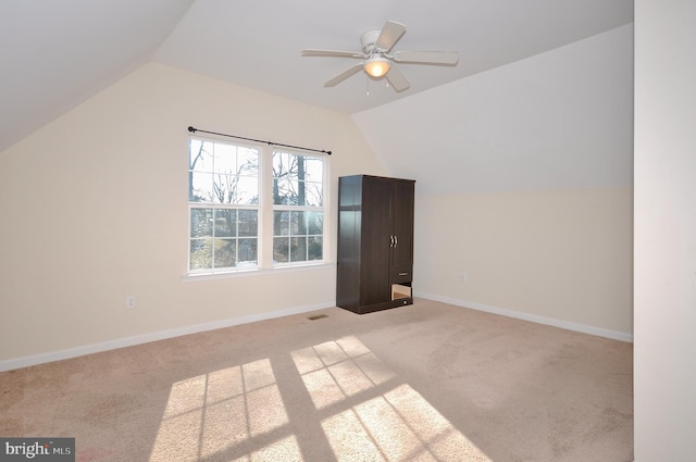 bonus room featuring ceiling fan, light colored carpet, and vaulted ceiling