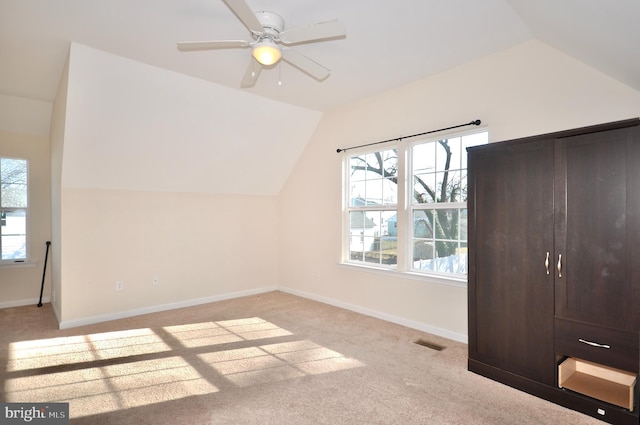 bonus room featuring ceiling fan, vaulted ceiling, and light carpet