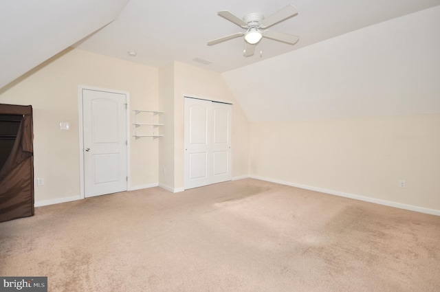 additional living space with ceiling fan, carpet, and vaulted ceiling