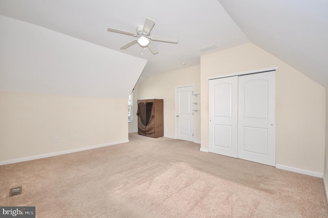 additional living space featuring ceiling fan, lofted ceiling, and light carpet