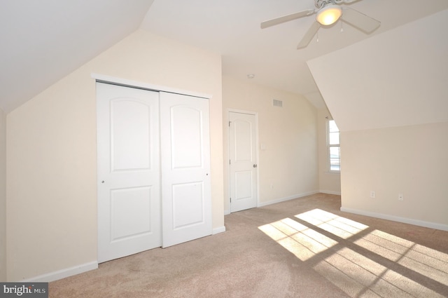 additional living space featuring vaulted ceiling, ceiling fan, and light colored carpet