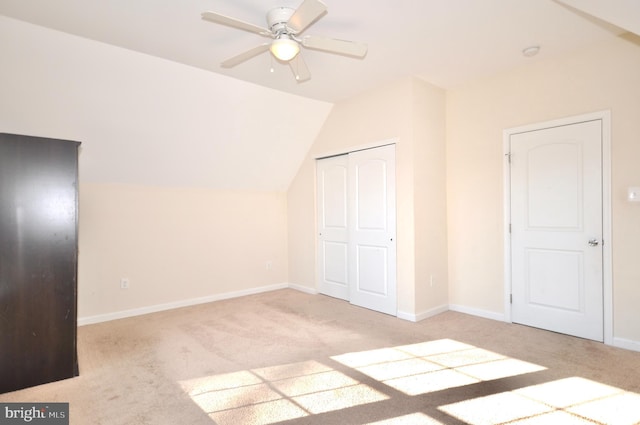 additional living space with ceiling fan, light carpet, and vaulted ceiling