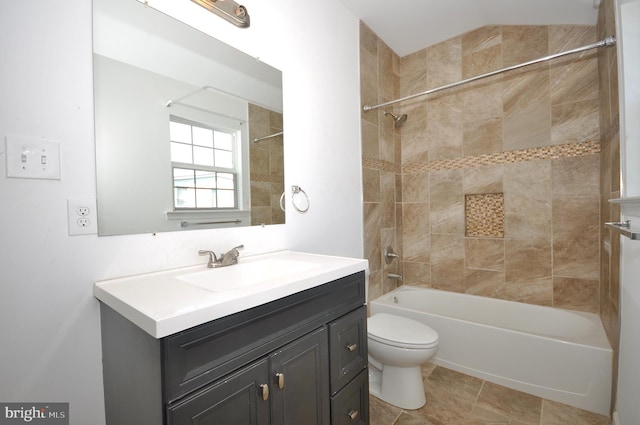 full bathroom with toilet, vanity, and tiled shower / bath