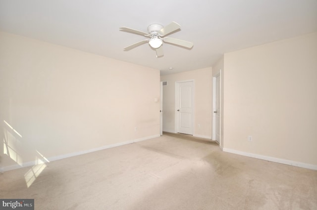 empty room with ceiling fan and light colored carpet