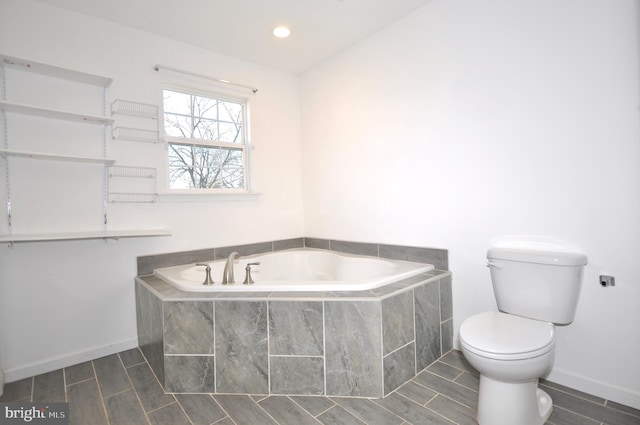 bathroom with tiled bath and toilet