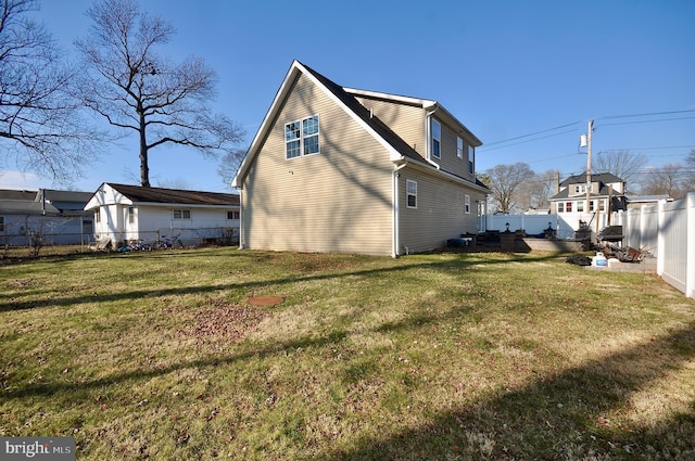 back of property featuring a yard