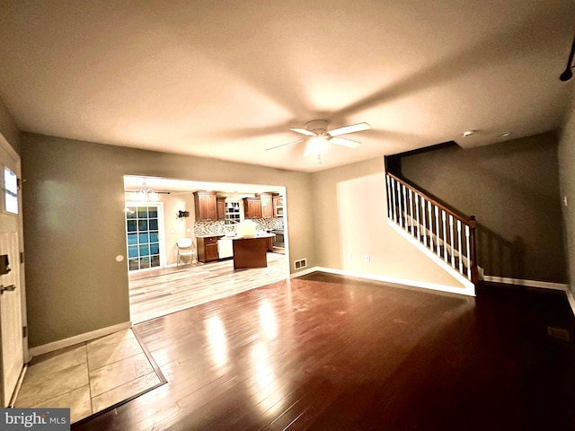 unfurnished living room featuring ceiling fan and light hardwood / wood-style flooring