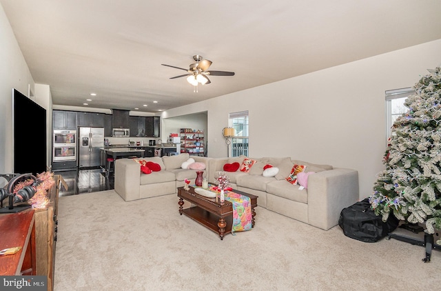 living area featuring plenty of natural light, carpet, ceiling fan, and recessed lighting