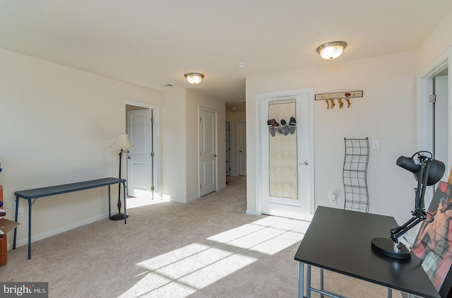 office area with light carpet and baseboards