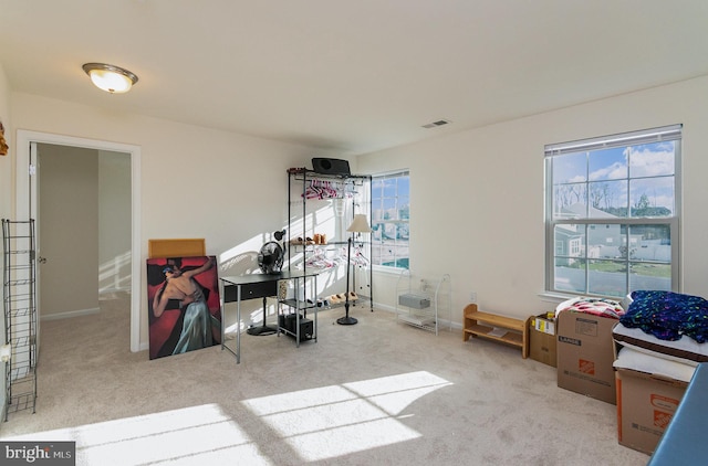 recreation room featuring carpet, visible vents, and baseboards