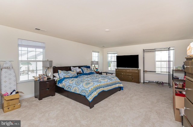 bedroom with carpet, visible vents, and baseboards