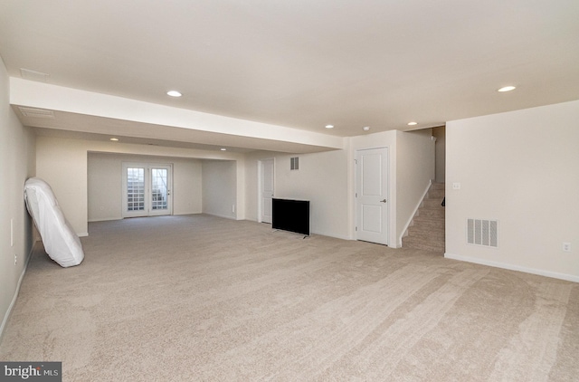 basement featuring stairs, light colored carpet, visible vents, and recessed lighting