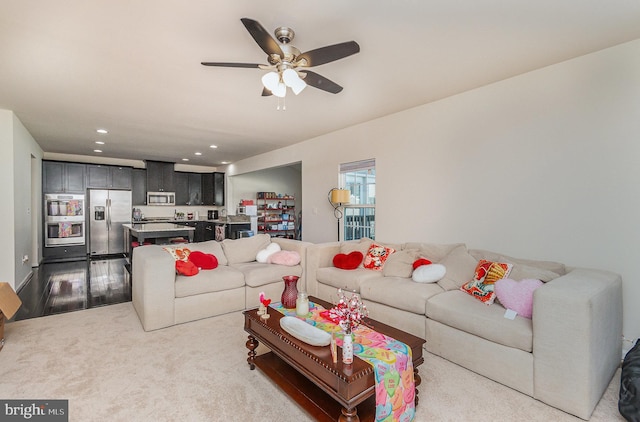 living area featuring recessed lighting, ceiling fan, and carpet