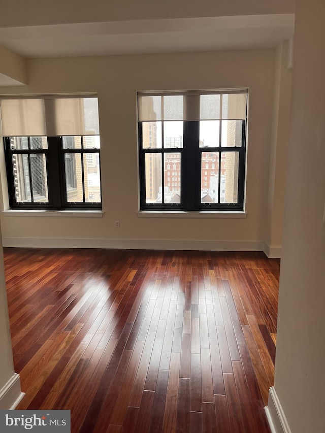 empty room featuring dark wood-type flooring