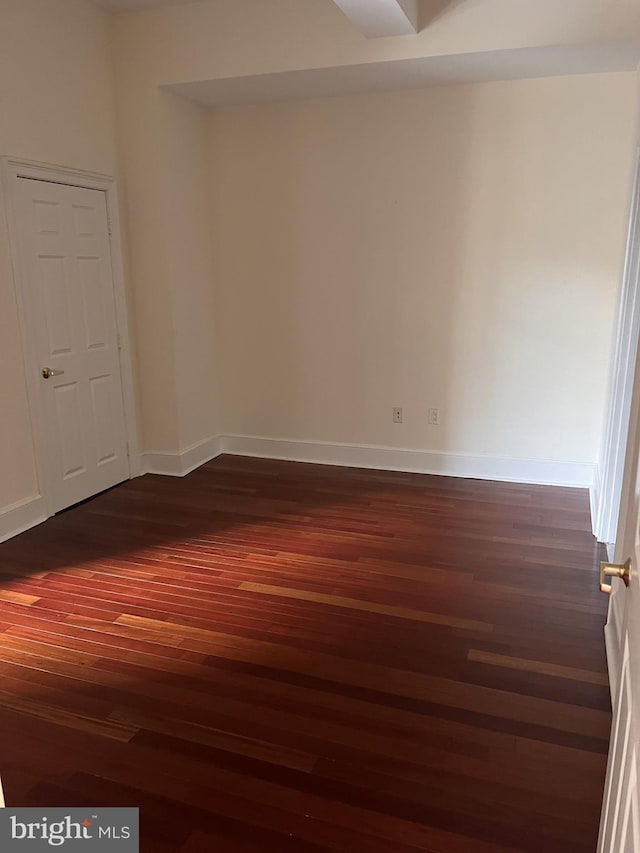 spare room featuring dark hardwood / wood-style floors