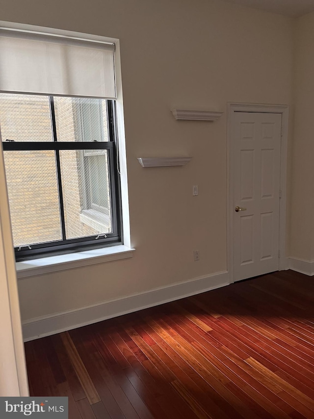 empty room featuring dark wood-type flooring