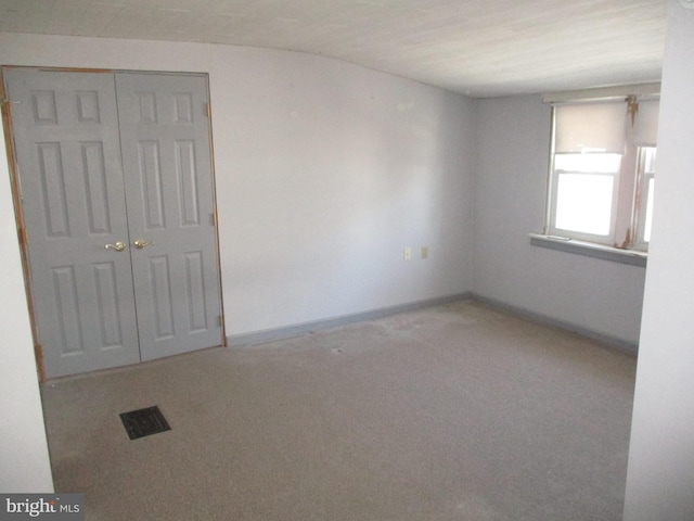 spare room featuring light colored carpet