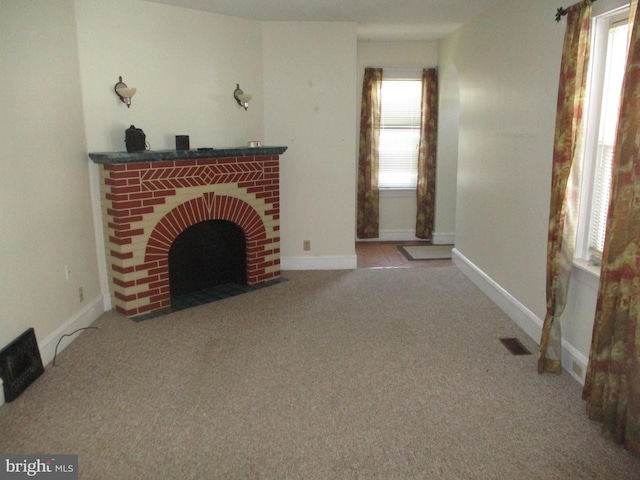 unfurnished living room featuring a fireplace and carpet floors