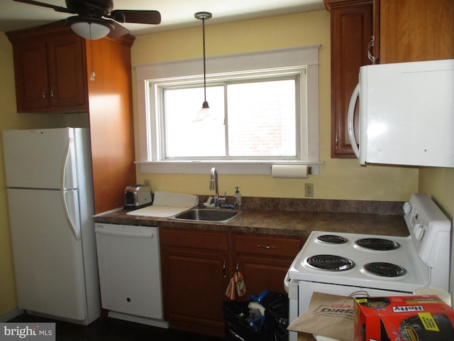 kitchen featuring sink, white appliances, ceiling fan, and hanging light fixtures