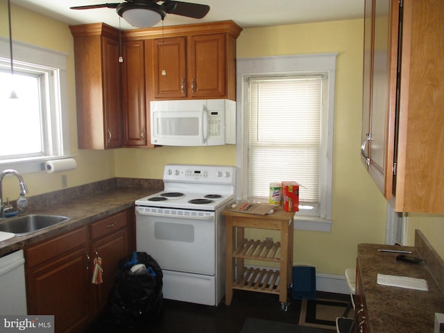 kitchen with white appliances, ceiling fan, and sink