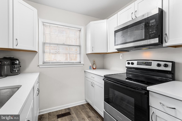 kitchen featuring white cabinets, dark hardwood / wood-style floors, sink, and stainless steel appliances