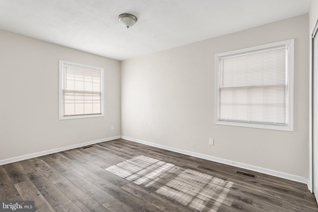 spare room featuring dark wood-type flooring