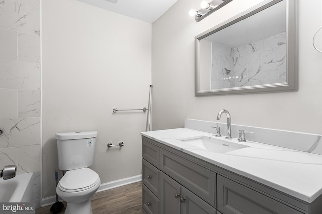 full bathroom with vanity, wood-type flooring, tub / shower combination, and toilet