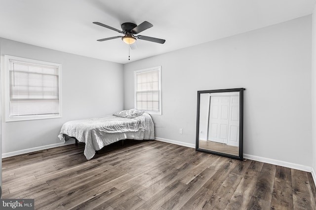 bedroom featuring ceiling fan and dark hardwood / wood-style floors