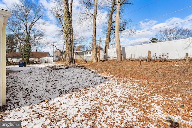 view of yard layered in snow