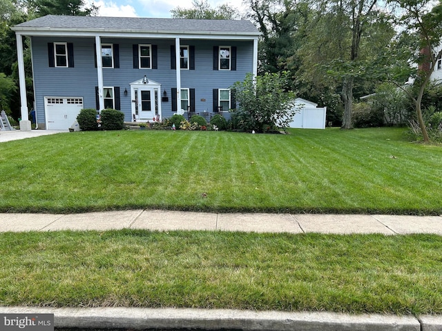 view of front facade with a front yard and a garage