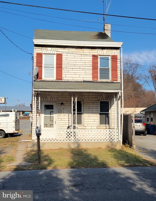 view of front of house featuring solar panels and covered porch