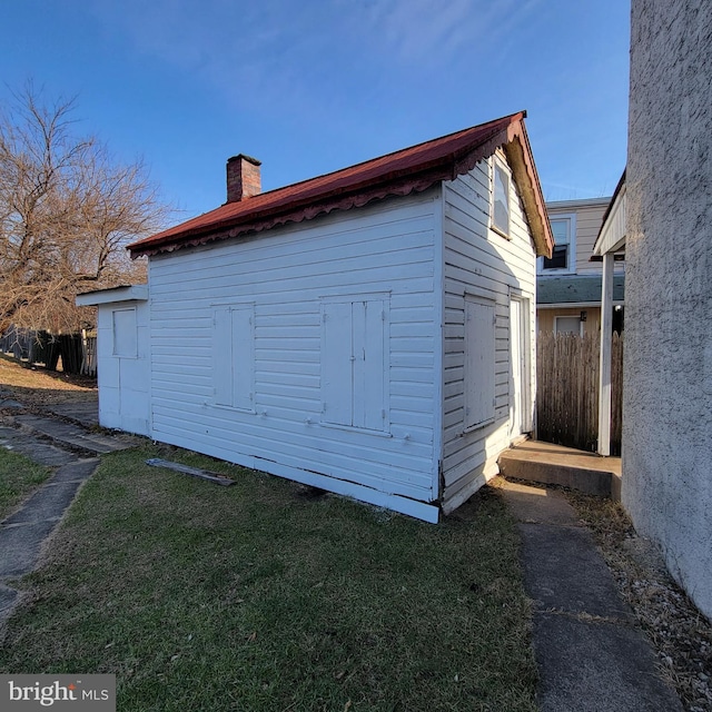 view of outbuilding with a lawn