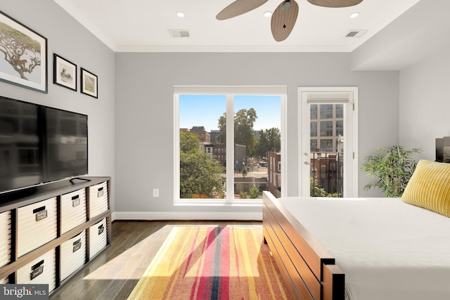 bedroom featuring ceiling fan, multiple windows, and crown molding