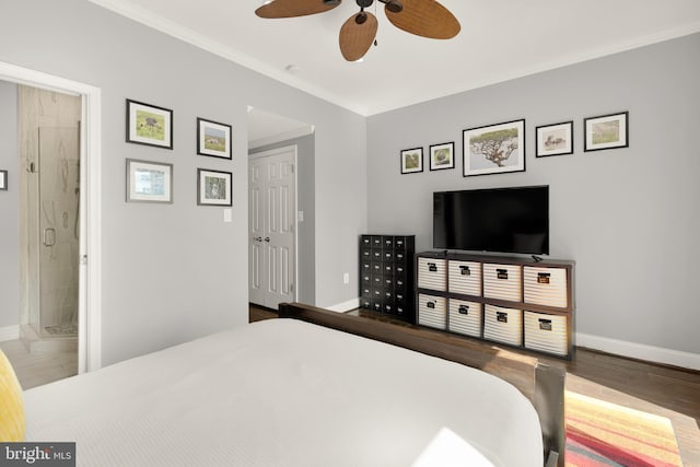 bedroom featuring ensuite bathroom, hardwood / wood-style floors, a closet, ornamental molding, and ceiling fan