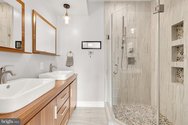 bathroom featuring walk in shower and vanity