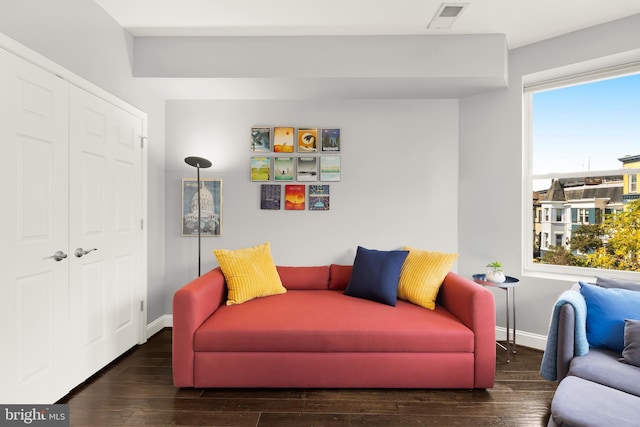 sitting room with a wealth of natural light and dark hardwood / wood-style flooring