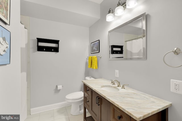 bathroom with vanity, toilet, and tile patterned floors