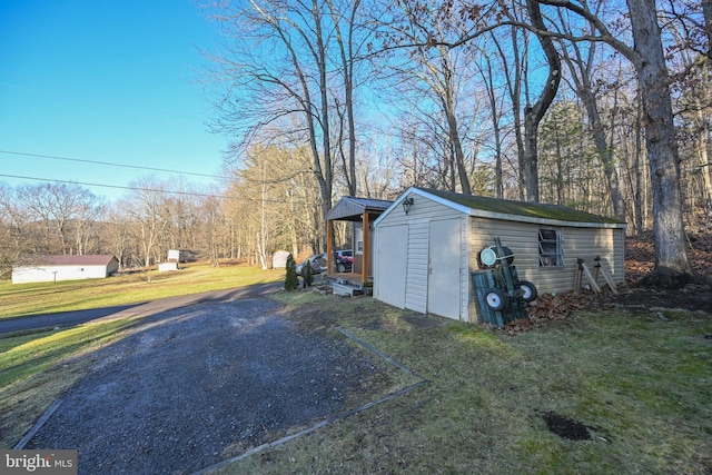 view of home's exterior featuring a yard and an outdoor structure