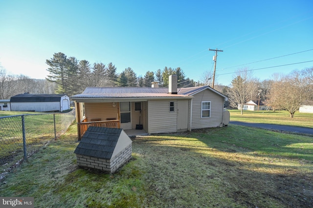 rear view of property with a yard