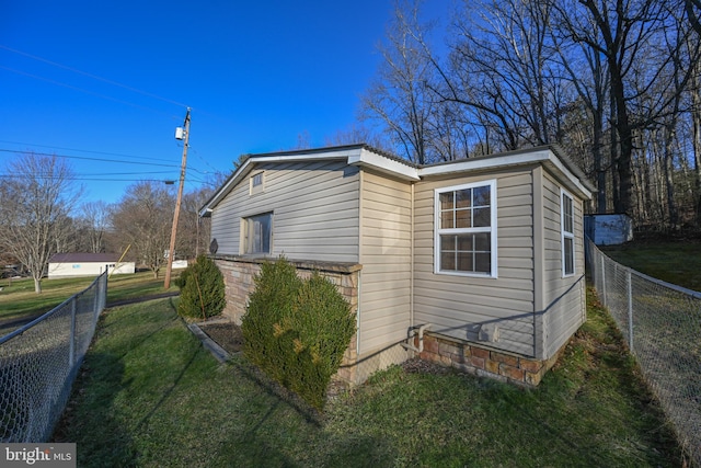 view of side of home featuring a yard