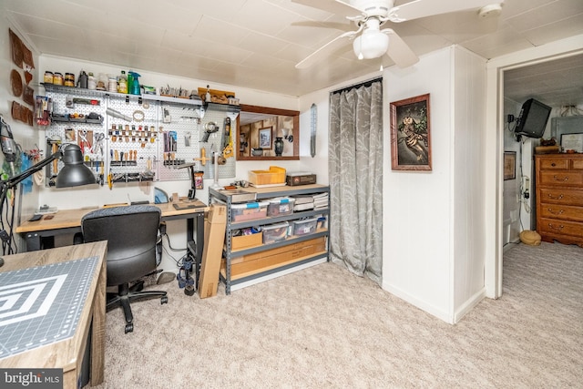 office with ceiling fan, light colored carpet, and a workshop area