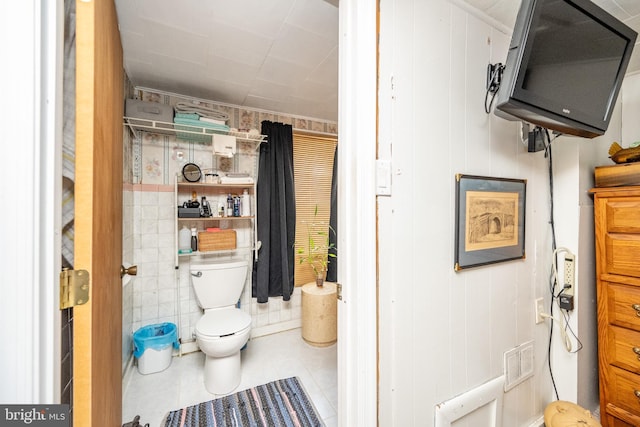 bathroom with toilet and tile patterned flooring