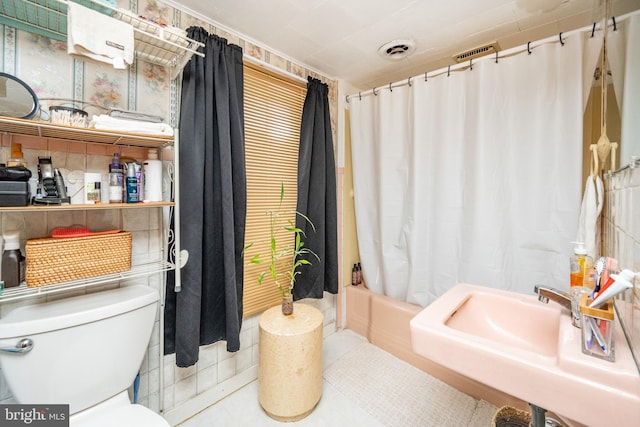 full bathroom with sink, tile patterned flooring, toilet, and shower / tub combo with curtain