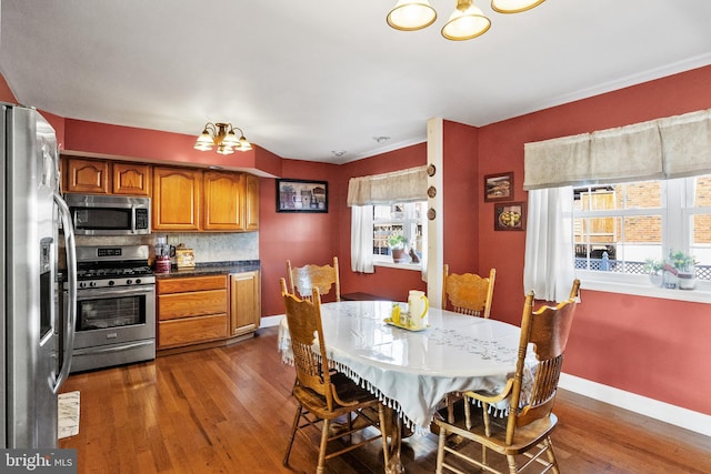 dining room with a notable chandelier and dark hardwood / wood-style floors